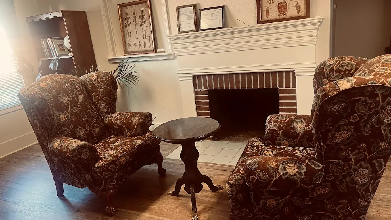 Two armchairs and a fireplace in Resolution Health's waiting room